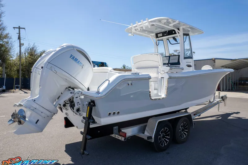 Slide: The Image of 2026 Sea Hunt Ultra 265 SE boat on trailer with Yamaha engine, parked outdoors. - 42