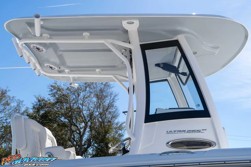Slide: The Image of 2026 Sea Hunt Ultra 265 SE boat with T-top and sleek design against blue sky. - 5