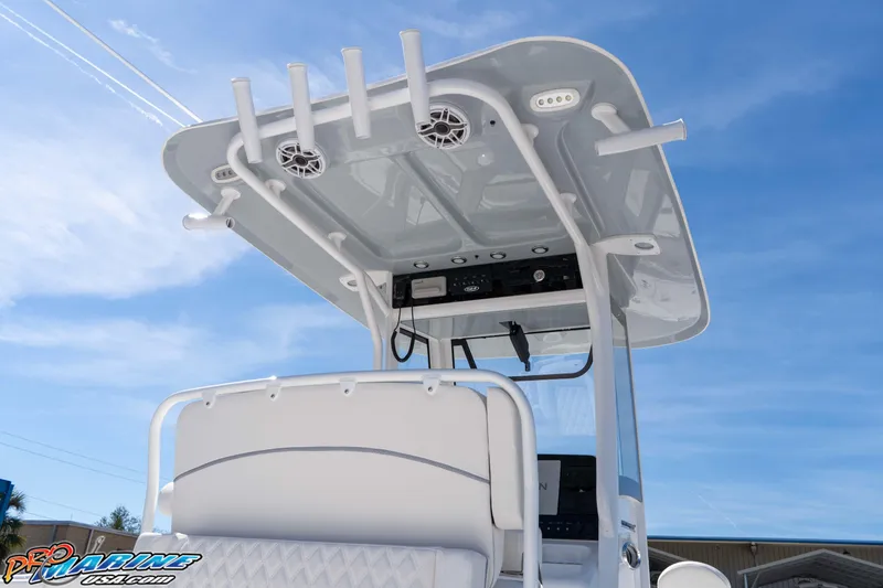 Slide: The Image of 2026 Sea Hunt Ultra 265 SE boat with T-top and rod holders against blue sky. - 6