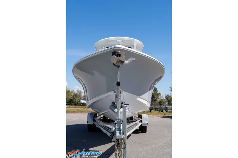 Slide: The Image of 2026 Sea Hunt Ultra 265 SE boat on trailer, front view under clear blue sky. - 8