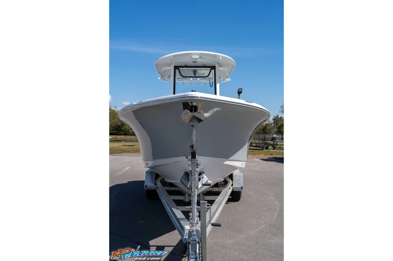 Slide: The Image of 2026 Sea Hunt Ultra 265 SE boat on trailer, front view under clear blue sky. - 9