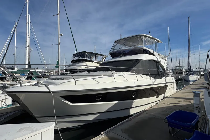 Slide: The Image of 2020 Beneteau Monte Carlo 52 yacht docked at marina under clear sky. - 1