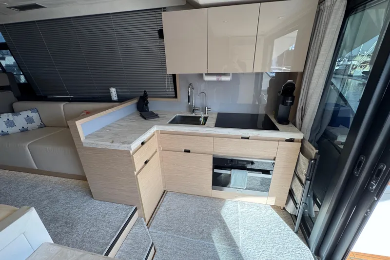 Slide: The Image of Modern kitchen interior of 2020 Beneteau Monte Carlo 52 yacht with sleek cabinetry and appliances. - 11