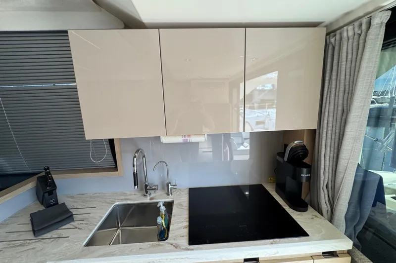 Slide: The Image of Modern kitchen in 2020 Beneteau Monte Carlo 52 yacht with sleek cabinetry and appliances. - 15