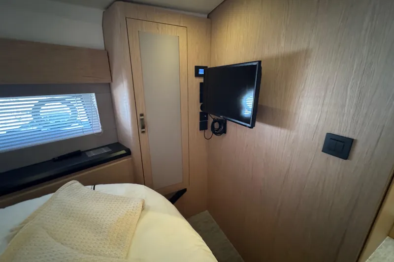Slide: The Image of Interior of 2020 Beneteau Monte Carlo 52 yacht cabin with TV and window blinds. - 35