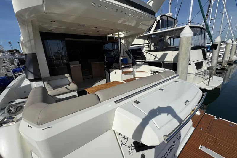Slide: The Image of 2020 Beneteau Monte Carlo 52 yacht docked, featuring spacious seating and elegant design. - 4