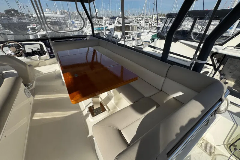 Slide: The Image of Luxurious seating area on 2020 Beneteau Monte Carlo 52 yacht with polished wooden table. - 42