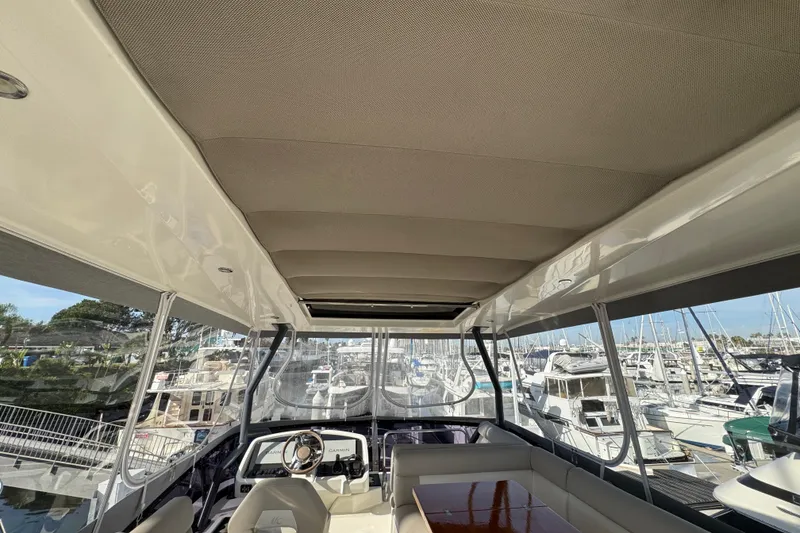 Slide: The Image of Interior view of 2020 Beneteau Monte Carlo 52 yacht, featuring helm and seating area. - 52