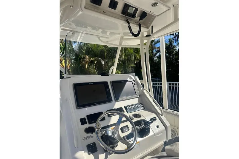 Slide: The Image of 2015 Regulator 28 Forward Seating boat console with steering wheel and navigation screens. - 15