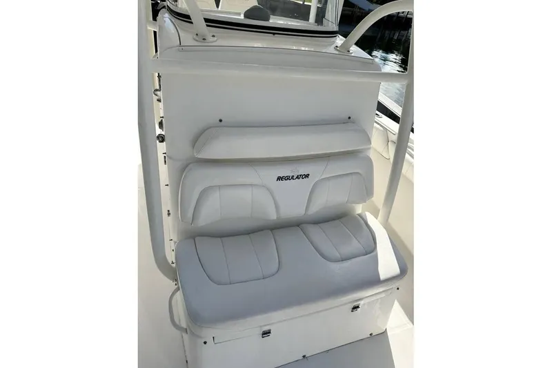 Slide: The Image of 2015 Regulator 28 Forward Seating boat interior with cushioned seats. - 22