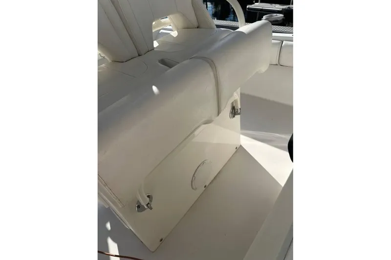 Slide: The Image of 2015 Regulator 28 Forward Seating boat interior with white cushioned seating. - 25