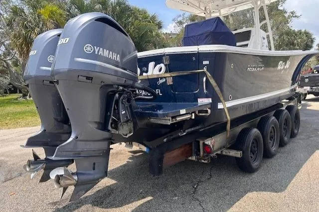 Slide: The Image of 2015 Regulator 28 Forward Seating boat with twin Yamaha engines on a trailer. - 31