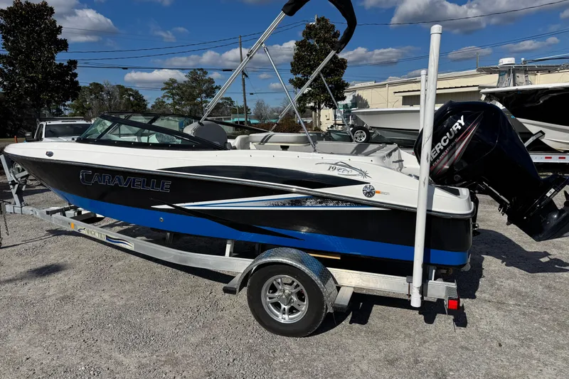 Slide: The Image of 2017 Caravelle 19 EBo Bowrider boat on trailer, featuring Mercury outboard motor. - 2
