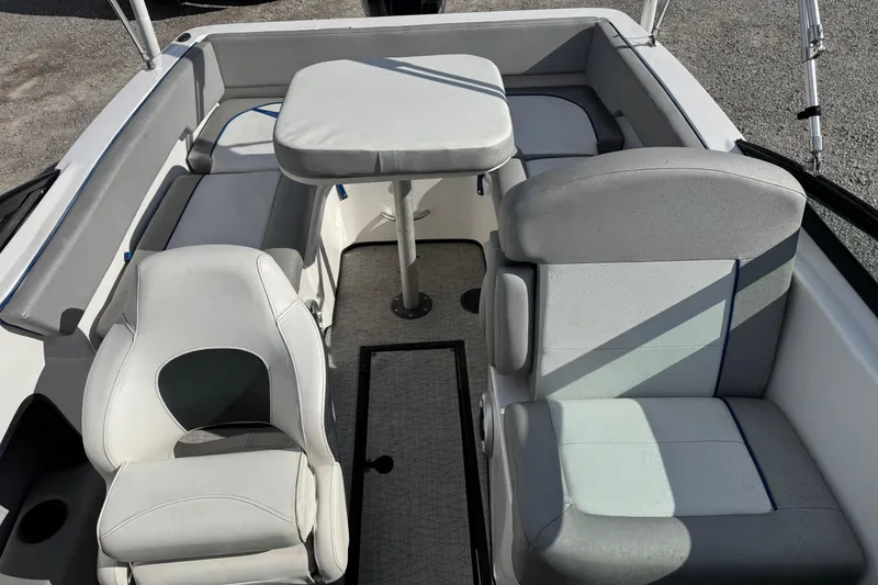 Slide: The Image of 2017 Caravelle 19 EBo Bowrider interior with seating and table setup. - 6