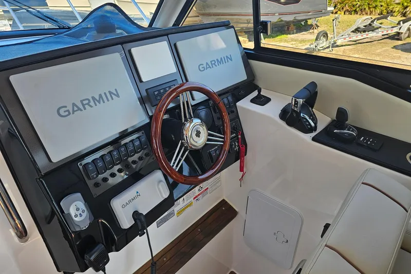 Slide: The Image of 2026 Cutwater C-288 Coupe helm with Garmin navigation displays and controls. - 10