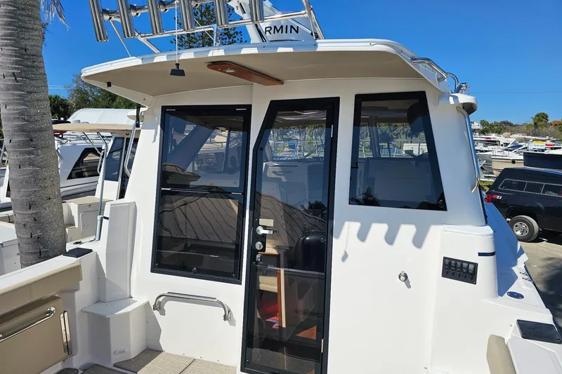 Slide: The Image of 2026 Cutwater C-288 Coupe boat docked, featuring sleek design and modern amenities. - 7