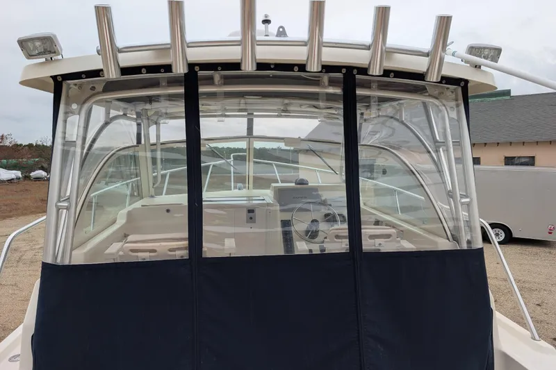 Slide: The Image of 2008 Parker 2510 XL Walkaround boat with enclosed cockpit and visible steering wheel. - 13