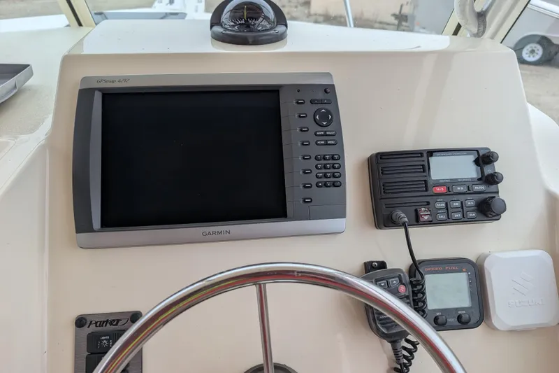 Slide: The Image of 2008 Parker 2510 XL Walkaround boat dashboard with Garmin GPS and marine radio. - 4
