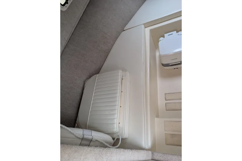 Slide: The Image of Interior of 2008 Parker 2510 XL Walkaround boat, featuring seating and storage area. - 6