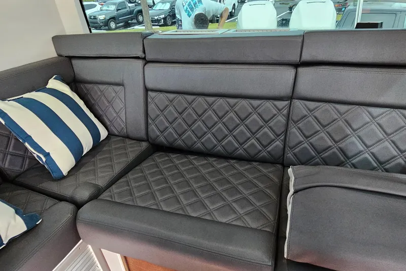Slide: The Image of Luxurious seating in 2020 Axopar 37 XC Cross Cabin with diamond-stitched upholstery and striped cushion. - 14