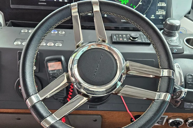 Slide: The Image of Steering wheel of 2020 Axopar 37 XC Cross Cabin with navigation controls. - 7