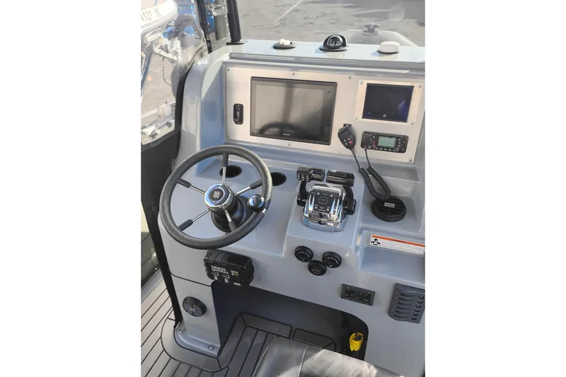 Slide: The Image of Valiant PT-750 2008 boat dashboard with steering wheel and navigation controls. - 10