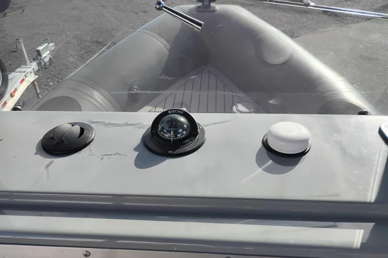 Slide: The Image of Control panel of 2008 Valiant PT-750 boat with compass and buttons. - 11