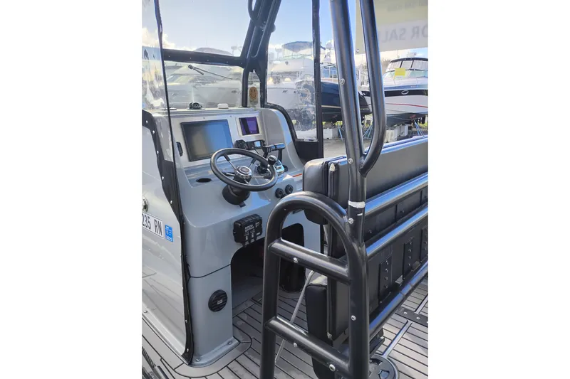 Slide: The Image of Valiant PT-750 boat dashboard, 2008 model, featuring steering wheel and navigation screens. - 15