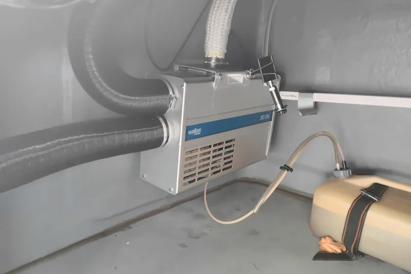 Slide: The Image of Valiant PT-750 heater system, 2008 model, with hoses and control unit in a gray compartment. - 17