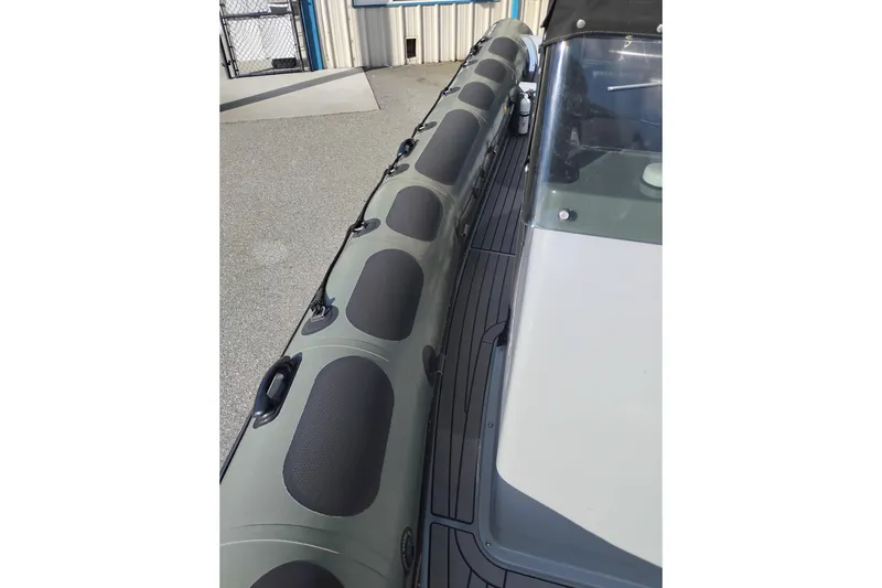 Slide: The Image of 2008 Valiant PT-750 boat, close-up of deck and inflatable side. - 20