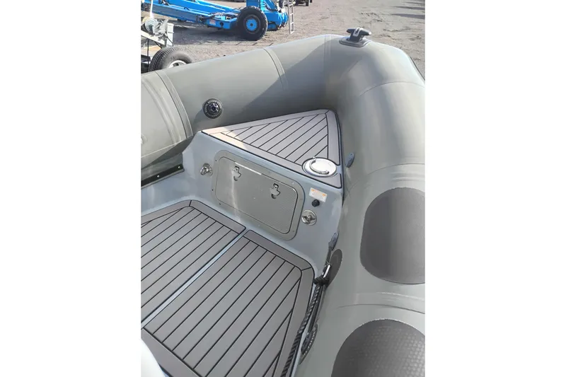Slide: The Image of 2008 Valiant PT-750 boat interior with gray seating and storage compartments. - 21