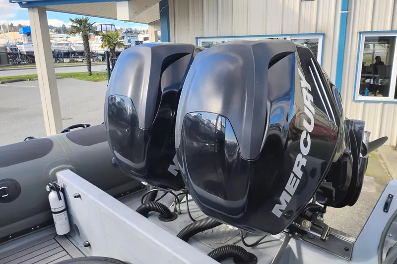Slide: The Image of Twin Mercury outboard engines on a 2008 Valiant PT-750 boat at a marina. - 4