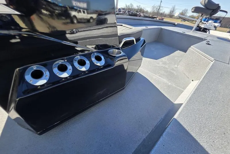 Slide: The Image of 2026 Xpress H24B Bay boat interior with rod holders and seating area. - 10