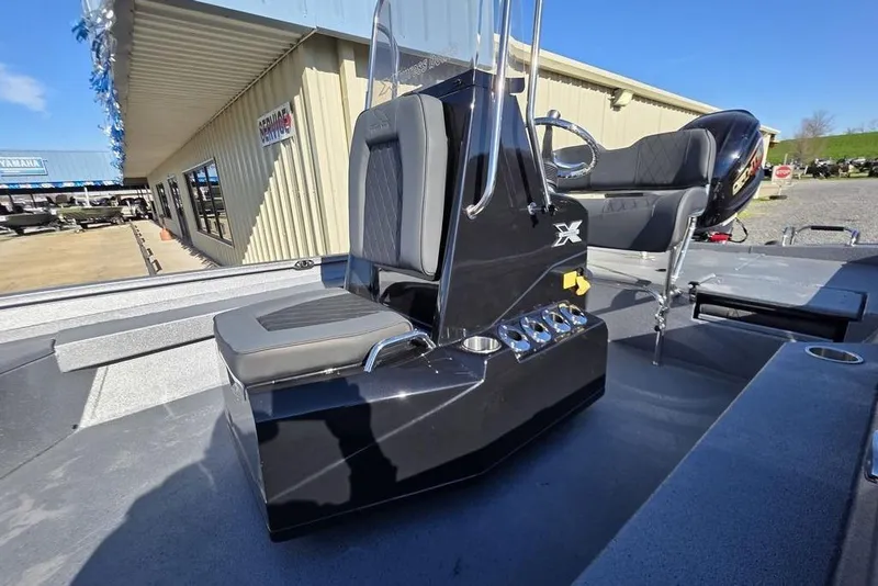 Slide: The Image of 2026 Xpress H24B Bay boat interior with sleek black console and seating. - 22