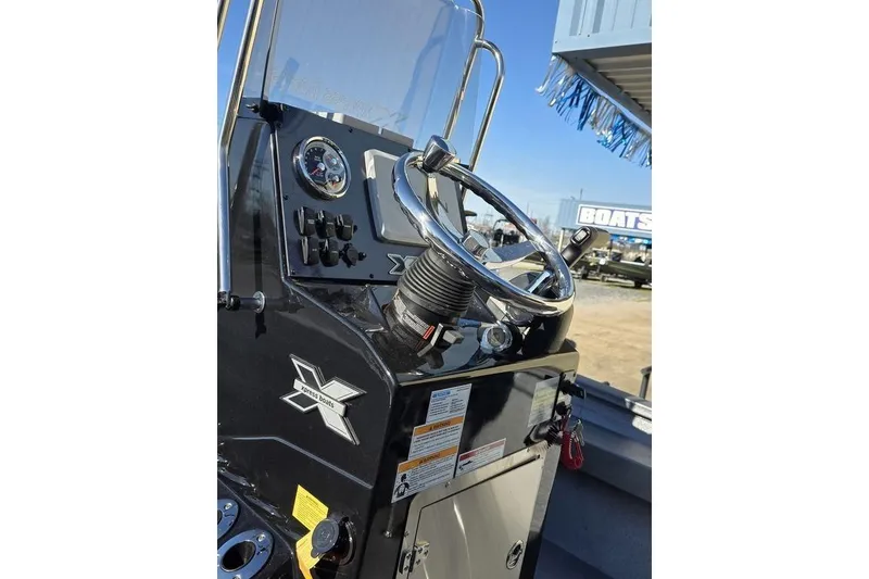 Slide: The Image of 2026 Xpress H24B Bay boat dashboard with steering wheel and controls. - 25