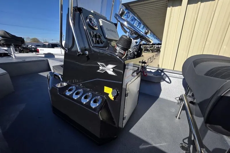 Slide: The Image of 2026 Xpress H24B Bay boat interior with steering console and seating. - 26