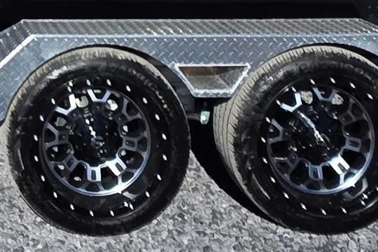 Slide: The Image of Dual black alloy wheels on a 2026 Xpress H24B Bay trailer. - 28