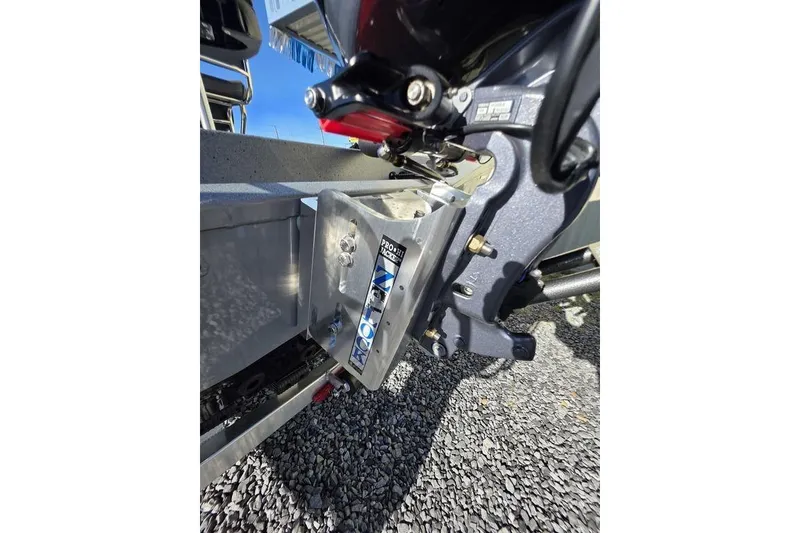 Slide: The Image of 2026 Xpress H24B Bay boat engine mount detail on gravel surface. - 5