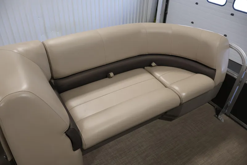 Slide: The Image of 2023 Sun Tracker Party Barge 18 DLX beige seating, indoor setting. - 13