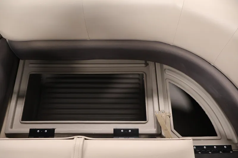 Slide: The Image of 2023 Sun Tracker Party Barge 18 DLX storage compartment with beige seating. - 14