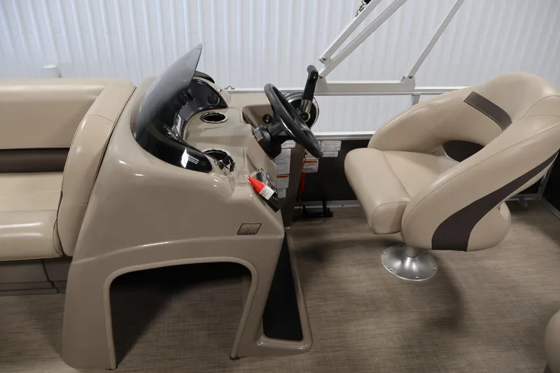 Slide: The Image of 2023 Sun Tracker Party Barge 18 DLX interior with steering console and seating. - 18
