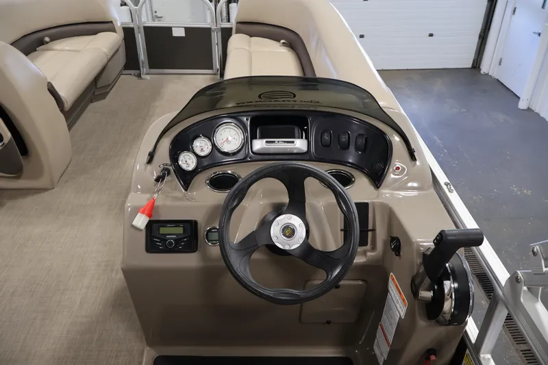Slide: The Image of 2023 Sun Tracker Party Barge 18 DLX dashboard with steering wheel and controls. - 20