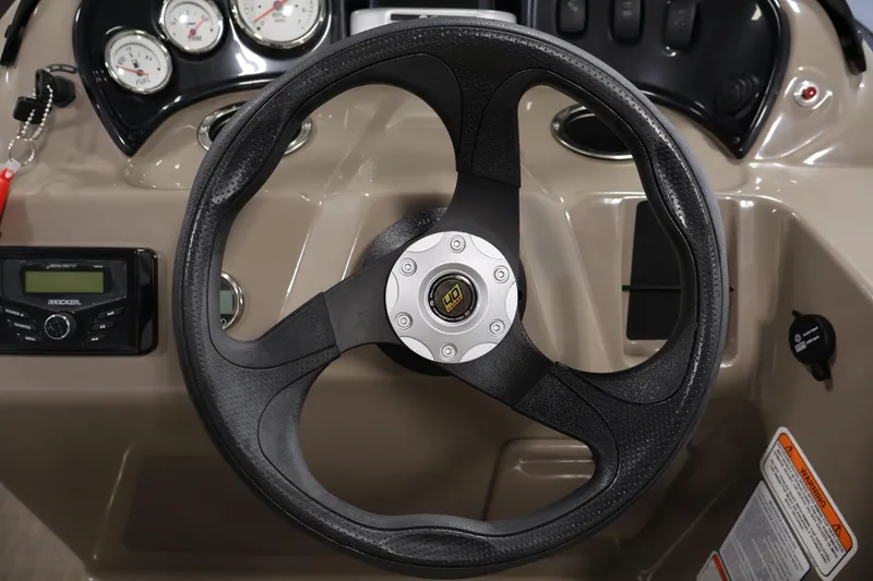 Slide: The Image of 2023 Sun Tracker Party Barge 18 DLX steering wheel and dashboard controls. - 21