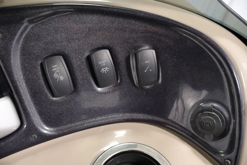 Slide: The Image of Control panel of 2023 Sun Tracker Party Barge 18 DLX with switches and 12V outlet. - 24