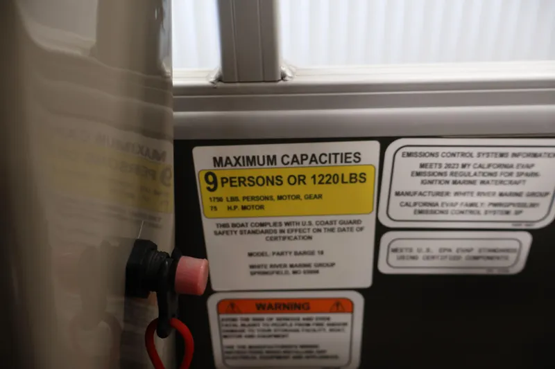 Slide: The Image of 2023 Sun Tracker Party Barge 18 DLX capacity label, maximum 9 persons or 1220 lbs. - 27