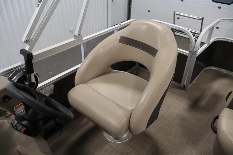 Slide: The Image of 2023 Sun Tracker Party Barge 18 DLX captain's chair and steering wheel in a boat interior. - 28