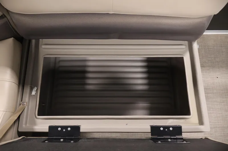 Slide: The Image of 2023 Sun Tracker Party Barge 18 DLX storage compartment, beige interior, open lid. - 30