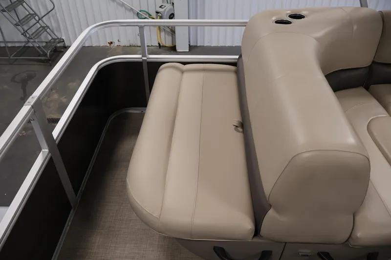 Slide: The Image of 2023 Sun Tracker Party Barge 18 DLX interior seating with beige upholstery and cup holders. - 32