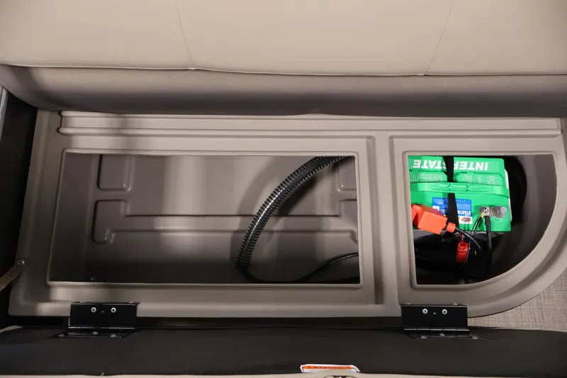 Slide: The Image of 2023 Sun Tracker Party Barge 18 DLX storage compartment with battery and wiring. - 33