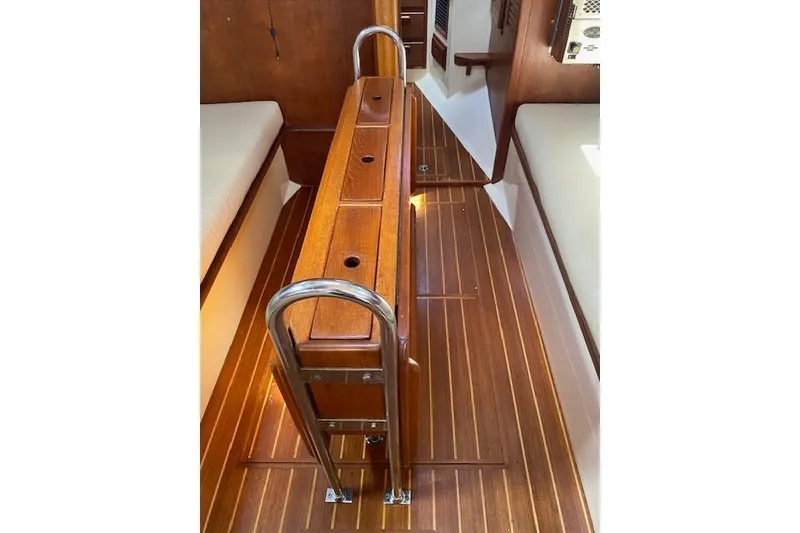 Slide: The Image of Interior of 1995 Pacific Seacraft Crealock 34 sailboat with wooden flooring and ladder. - 15